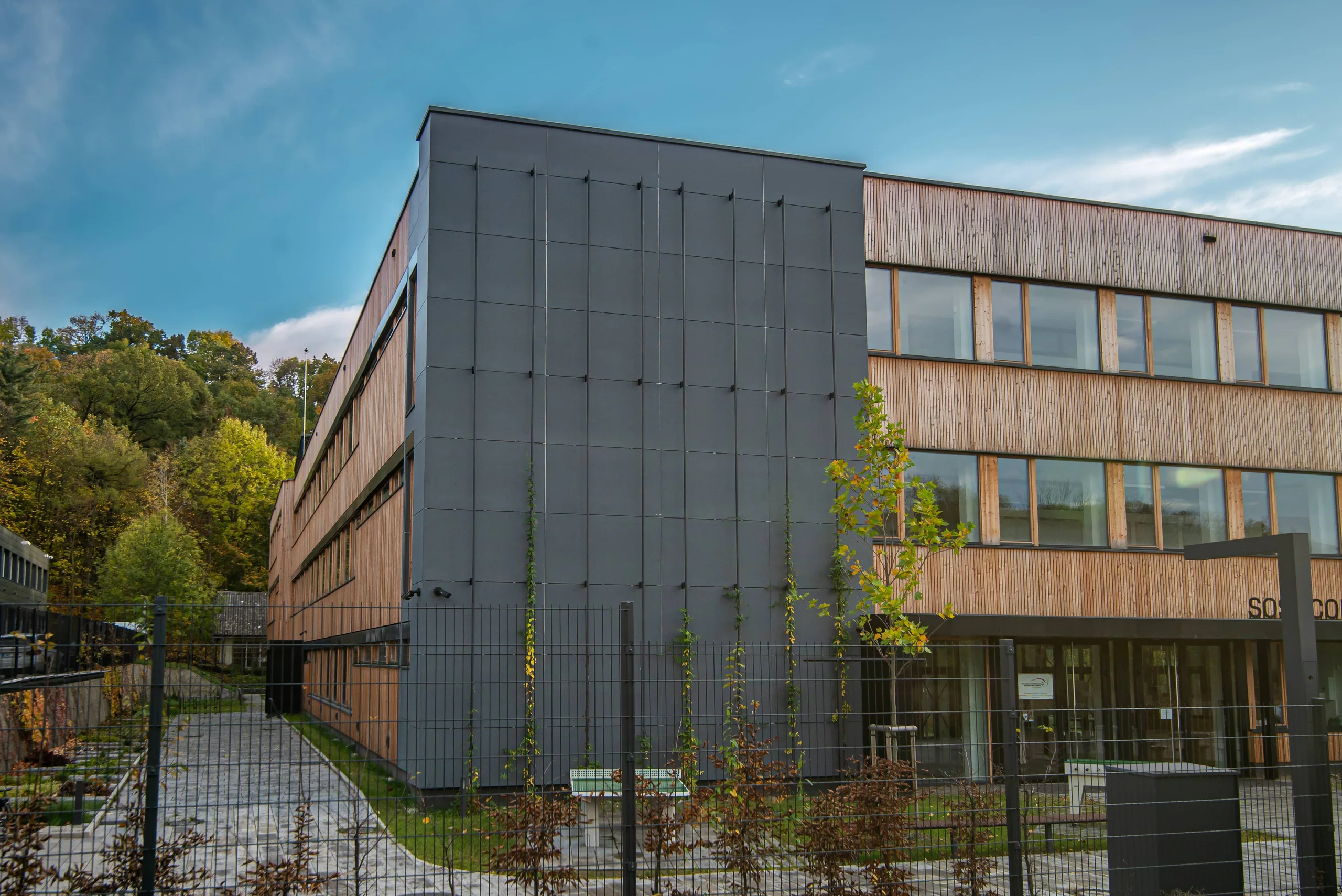 Ventilated façade combining timber and grey panels