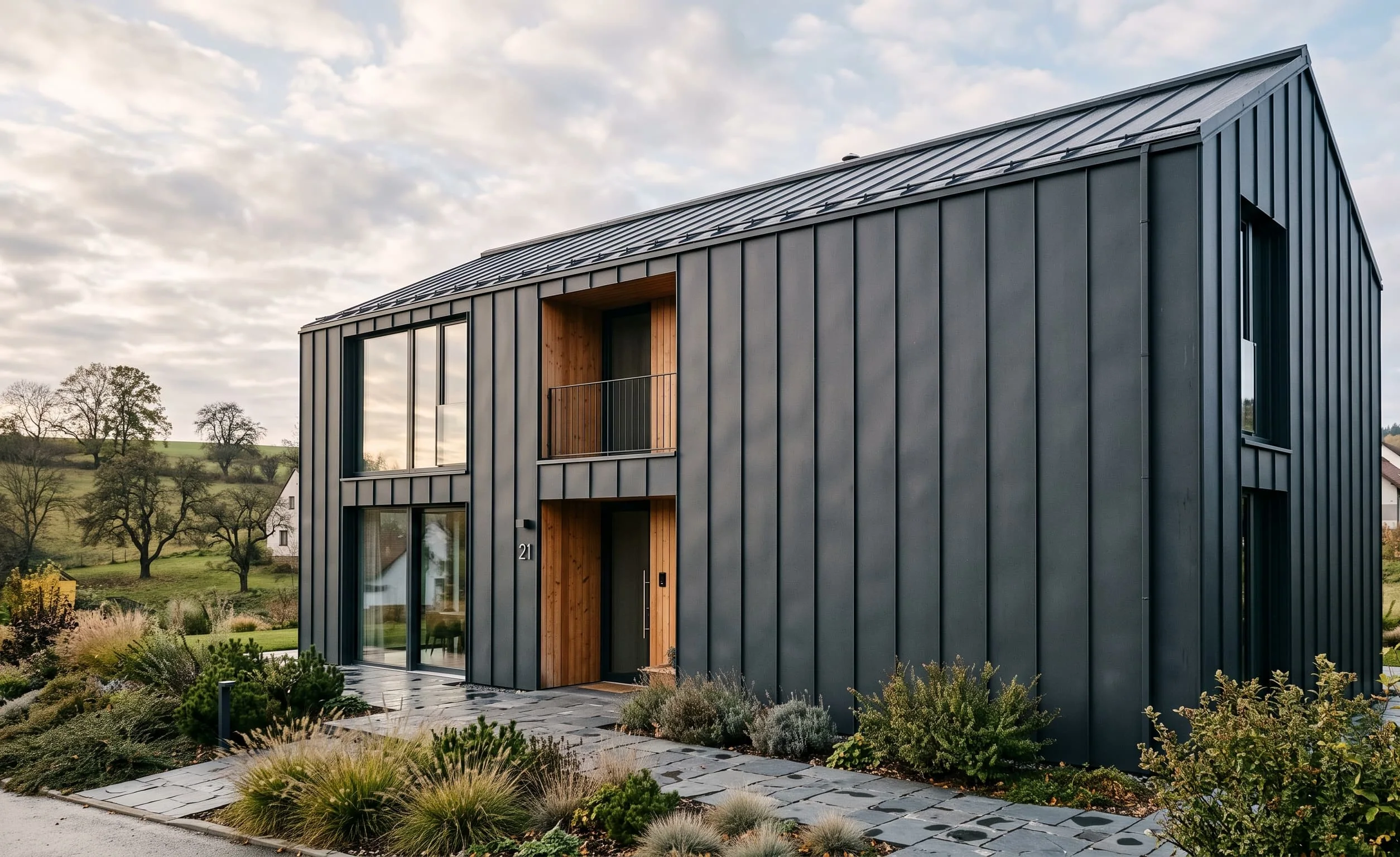 Family house with a dark standing-seam metal façade